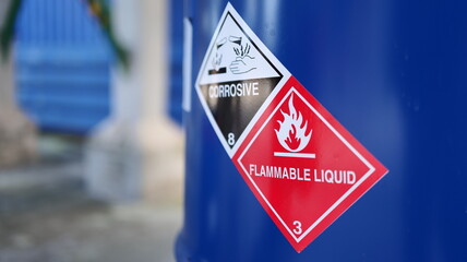 Corrosive warning sign label and flammable liquid warning sign label on the barrel tank. To warn...