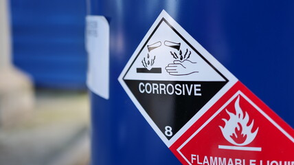 Corrosive warning sign label and flammable liquid warning sign label on the barrel tank. To warn...