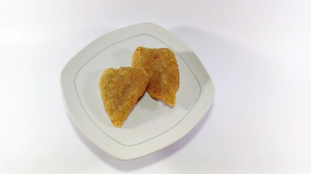 Empek-Empek, a Savory Indonesian Fishcake Delicacy Made from Prawns Instead of Fish and Tapioca, Placed on a White Squared Plate Against a White Background: A Unique Twist on a Traditional Favorite