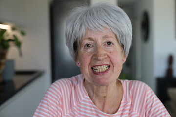 Offended senior woman faking a smile 