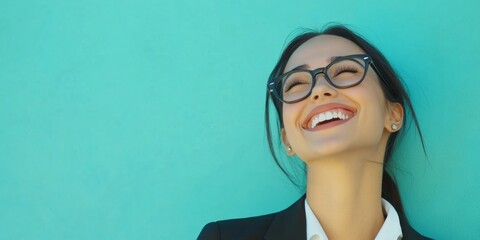 Confident Young Businesswoman Smiling: Professional Female Executive with Glasses Looking at Copy Space. Optimistic Career Woman Radiating Success and Opportunity. Perfect for Corporate Advertising, J