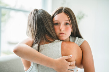 Worried teen with mother consoling share problem with someone close concept