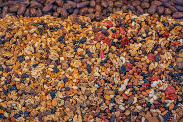 Colorful assortment of dried fruits, nuts, and seeds at local market, rich variety of textures and colors