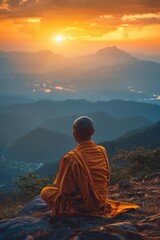 Obraz premium A person sits on a rock overlooking a stunning sunset, great for travel or adventure themes