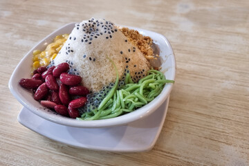Closeup of authentic ice kacang or shaved ice with ingredients like red beans, cendol and sweet corn is popular traditional sweet delicacy in Malaysia