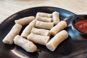 Close-up serving of steamed keropok lekor, popular traditional delicacy snack in Kuala Terengganu, Malaysia
