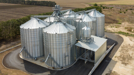 Aerial view of agricultural Silos. Storage and drying of grains, wheat, corn, soy, sunflower. Elevator silos © dechevm