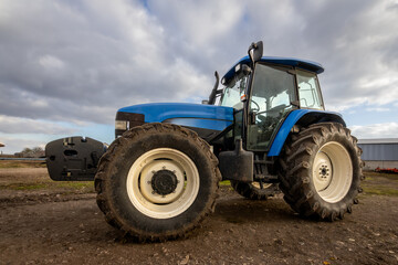 Big blue modern tractor in farm