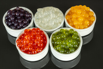 Different tapioca pearls for bubble tea. Bubble tea ingredients arrangement in bowls