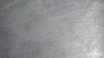 The steel plate surface has scratches from use.