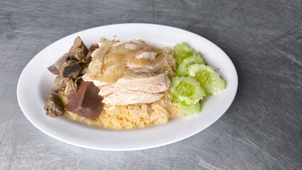 Chicken rice in a white plate on the dining table