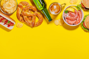 A vibrant photo showcasing a glass of beer surrounded by various snacks and fast food