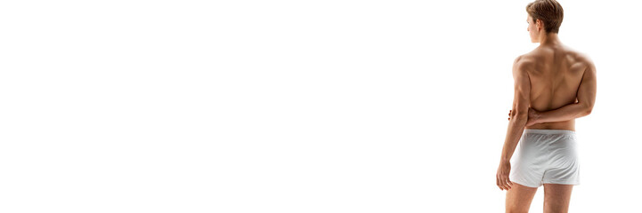 Fototapeta premium Banner. Rear view photo of male model posing in white underwear against white studio background with negative space o insert text. Concept of male health, natural beauty people, fashion, self care.