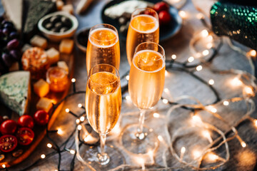 Glasses of sparkling wine or champagne served on the table for Christmas or New Year eve celebration.
