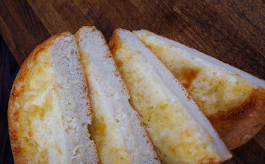 Khachapuri. Bun with cheese on a wooden background. Cheese pie.