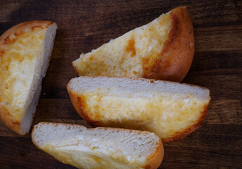 Khachapuri. Bun with cheese on a wooden background. Cheese pie.
