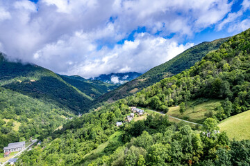Naklejka premium Vallée du Biros - Pyrénées - Ariège - Mountain village nestled in a lush green valley