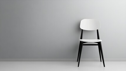 A white chair is sitting in front of a wall