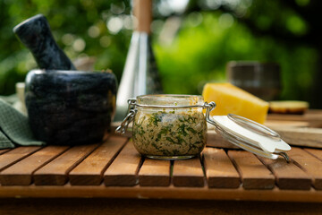 jar of pesto sauce on the table. Pesto sauce cooking. Basil, olive oil, parmesan, garlic, pine nuts