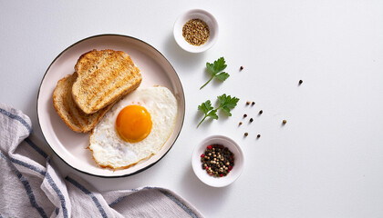 Tasty fried egg with bread and spices served for breakfast. Delicious food. Flat lay. Classic style.