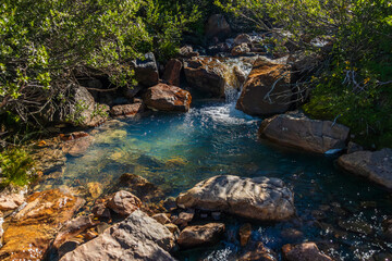 clear blue pool from mountain stream in the early morning