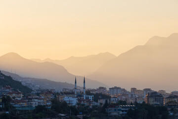 Alanya city with mosque  and distant mountain at morning sunrise, Turkey cityscape