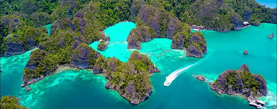 
Discover Raja Ampat in Papua, Indonesia, with amazing turquoise waters, stunning sandbanks, and vibrant sea life. Perfect for a holiday, enjoy a drone's aerial view of this tropical paradise