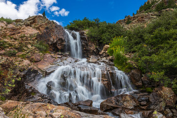 mountain river waterfall long exposure in the summer afternoon