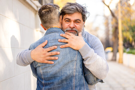 Gay couple embracing lovingly on a sunny day