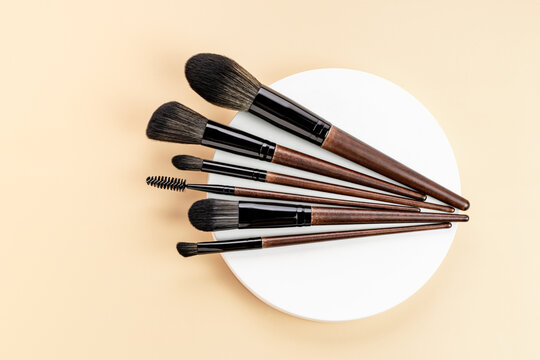 Variety of Make-up Brushes on Pastel Background