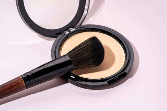 Elegant makeup brush on compact powder close-up