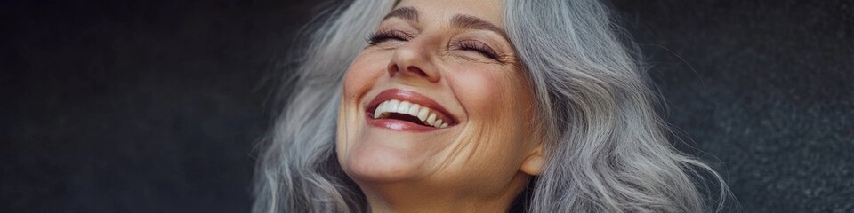 Fototapeta premium Elegant Portrait of a Beautiful Senior Woman with Grey Hair Smiling: Perfect for Skincare, Dental Care, and Health Beauty Campaigns. Minimalist Design with Copy Space for Marketing and Promotional Use