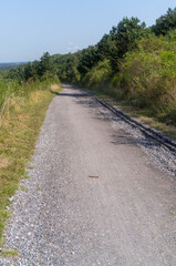 wide gravel path on a hill with a distant view