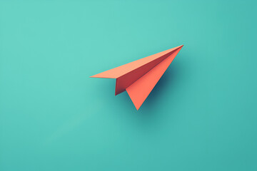 Orange paper airplane on a teal background