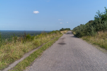 wide gravel path on a hill with a distant view