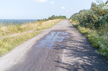 wide gravel path on a hill with a distant view