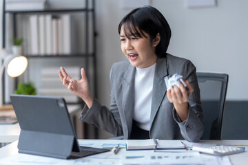 Stressed businesswoman getting angry yelling at computer having video call at office