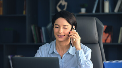 Businesswoman smiling while talking on the phone