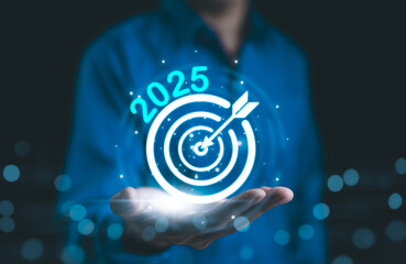 The 2025 new year business goals concept. Businessman hand show goals and targets for the company...