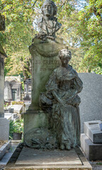 Naklejka premium Paris, France - 08 16 2024: Montmartre cemetery. View of graves in the cemetery.