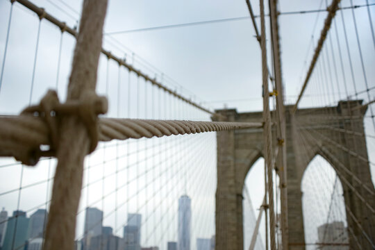 Close-up view of Brooklyn Bridge's cable with Manhattan backdrop