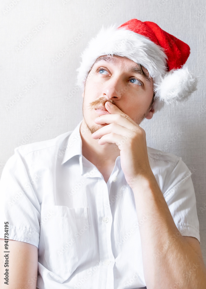 Canvas Prints pensive young man in santa hat