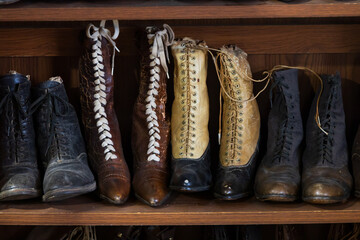 Old fashioned shoes and boots on shelves