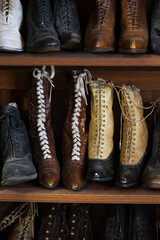 Old fashioned shoes and boots on shelves