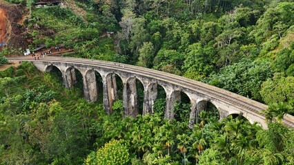 Fototapeta premium The Nine Arch Bridge. Old bridge in the mountains. Drone view. Ella, Sri Lanka.