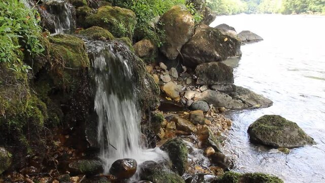A stream cascading noisily into a river