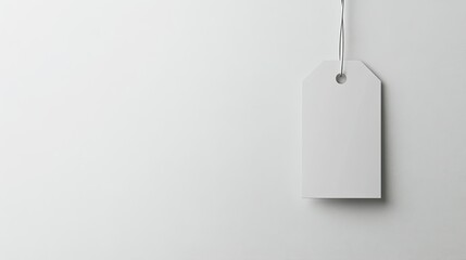 A plain price tag hanging on a white retail display, no letters or numbers, with ample copy space around it.