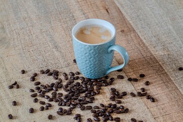 A cup of coffee with coffee beans