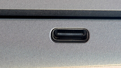 USB-C data charging monitor output port input on the side of a modern laptop computer, macro shot,...