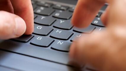 Man typing fast on a new gray modern laptop keyboard, closeup, real time, one person. Creative content writing, quickly typing something on a keyboard. Blogging, programming simple abstract concept